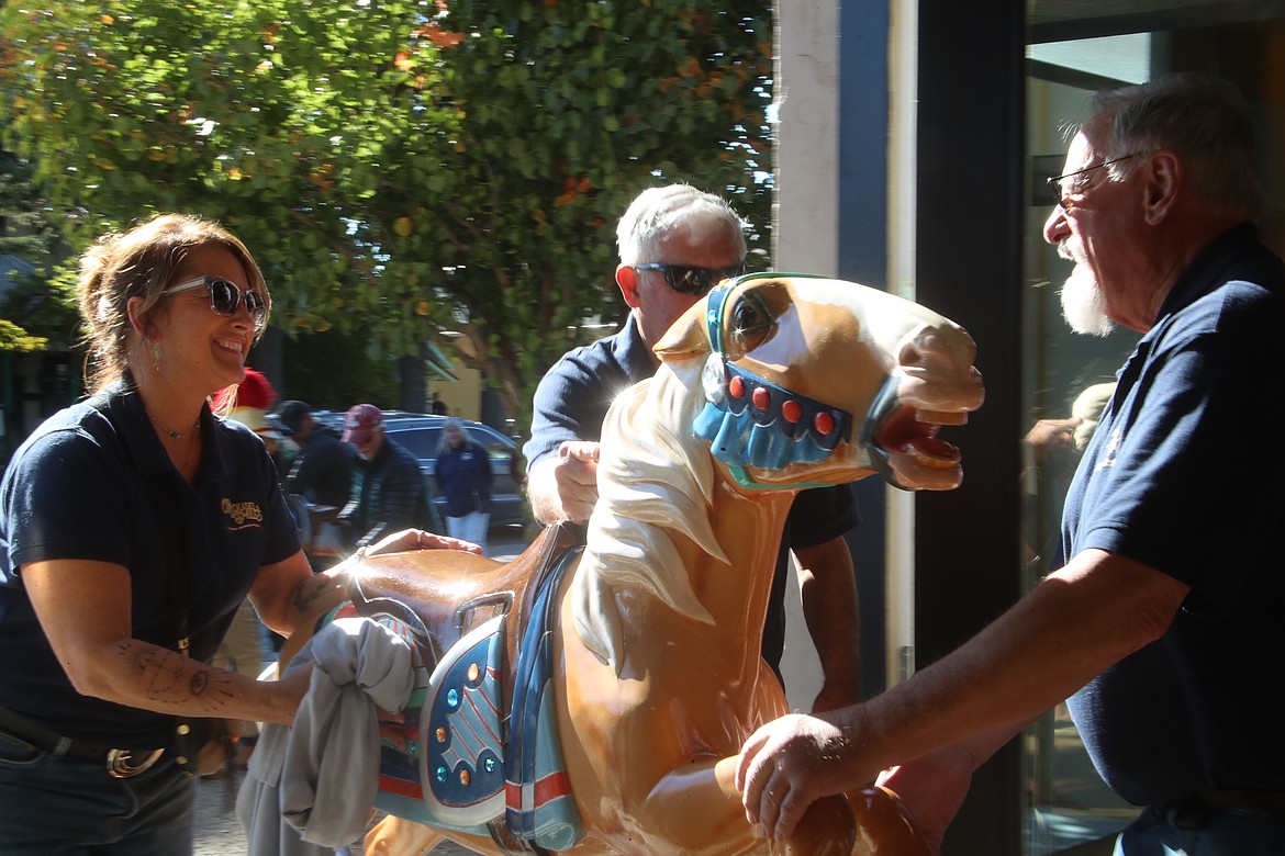 Volunteers bring a Carousel of Smiles pony into its new Church Street home where the nonprofit hopes to create a showcase atrraction.