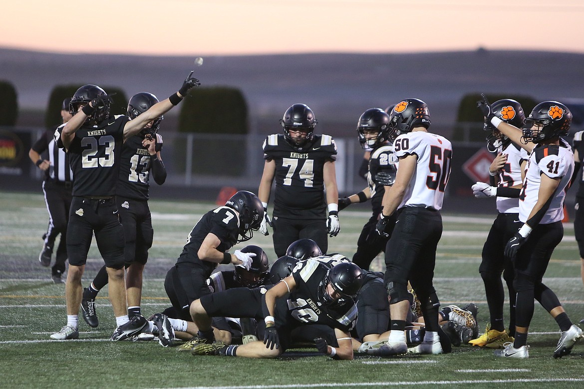 Royal defenders huddle around a loose ball during their game against Zillah on Sept. 27. The Knights held Prosser to eight points Friday night.