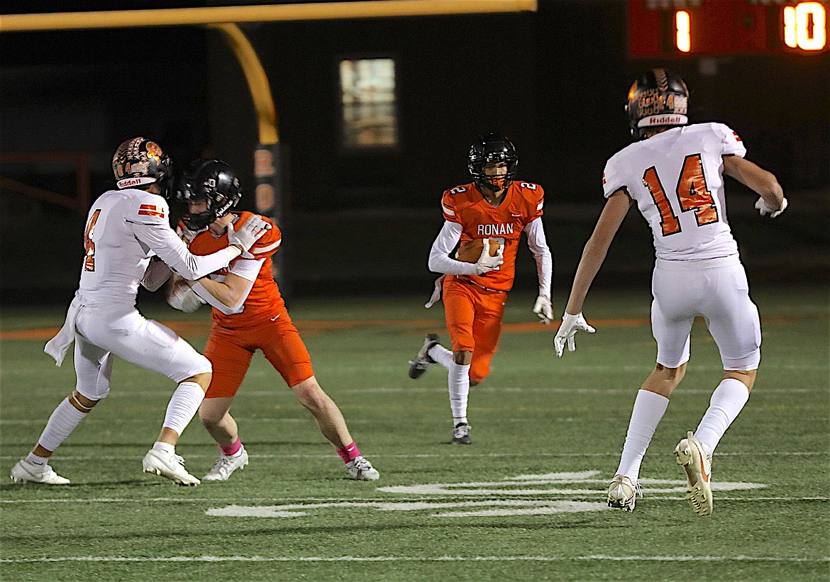Ronan's Hunter Qualtier moves the ball down the field with help from Laurance Lozeau during last Friday's game against the Frenchtown Broncs. (Susan Lake photo)