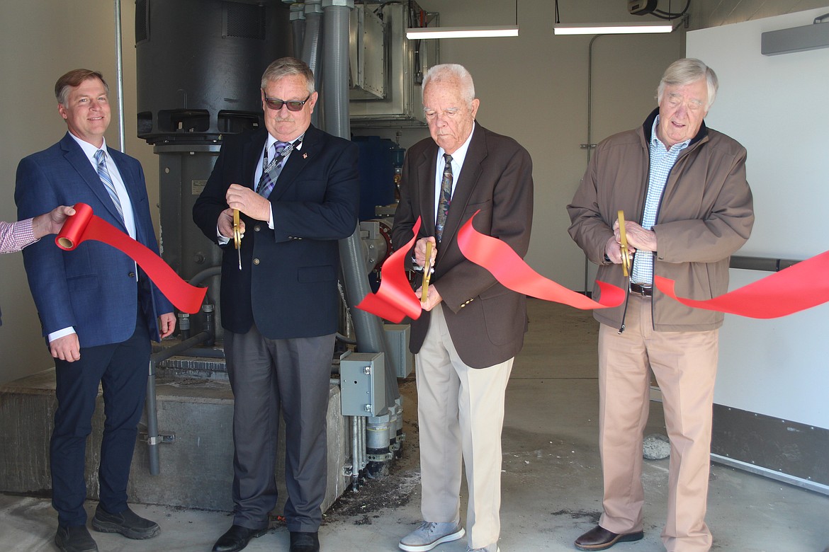 From left, Port of Moses Lake Dan Roach watches as commissioners Darrin Jackson, Kent Jones and Stroud Kunkel cut the ribbon on a new pump and pumphouse that are part of the port’s water reuse system.