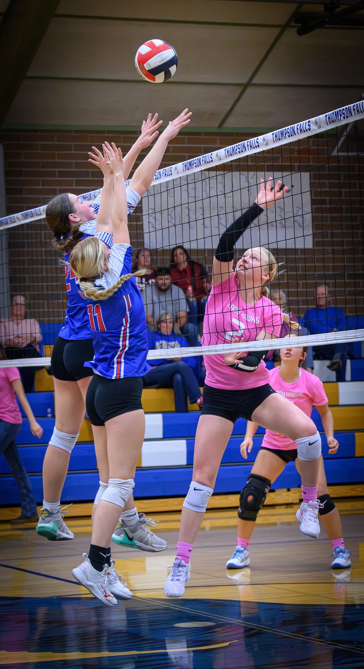 Thompson Falls sophomore Addy Deal tries to sneak a return past by Superior's Braelyn Mangold and Abbey Zebededo during their match in T Falls this past week.  (Photo by Tracy Scott)