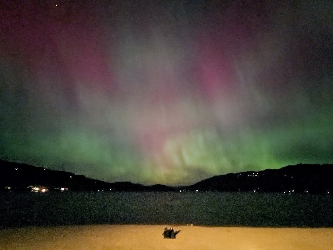 People flock to City Beach for an in-town view of the aurora borealis during a strong solar storm on Thursday, Oct. 10. (Kelsey Evans/Whitefish Pilot)