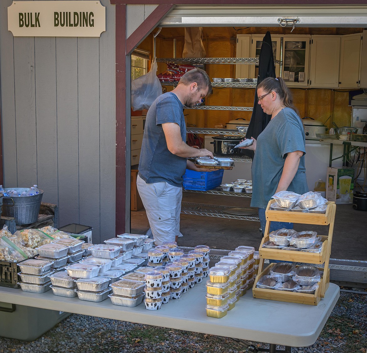 Volunteers Tyler Riffle and Carol Dykstra prepare food for sale at the Fall Festival. (Tracy Scott/Valley Press)