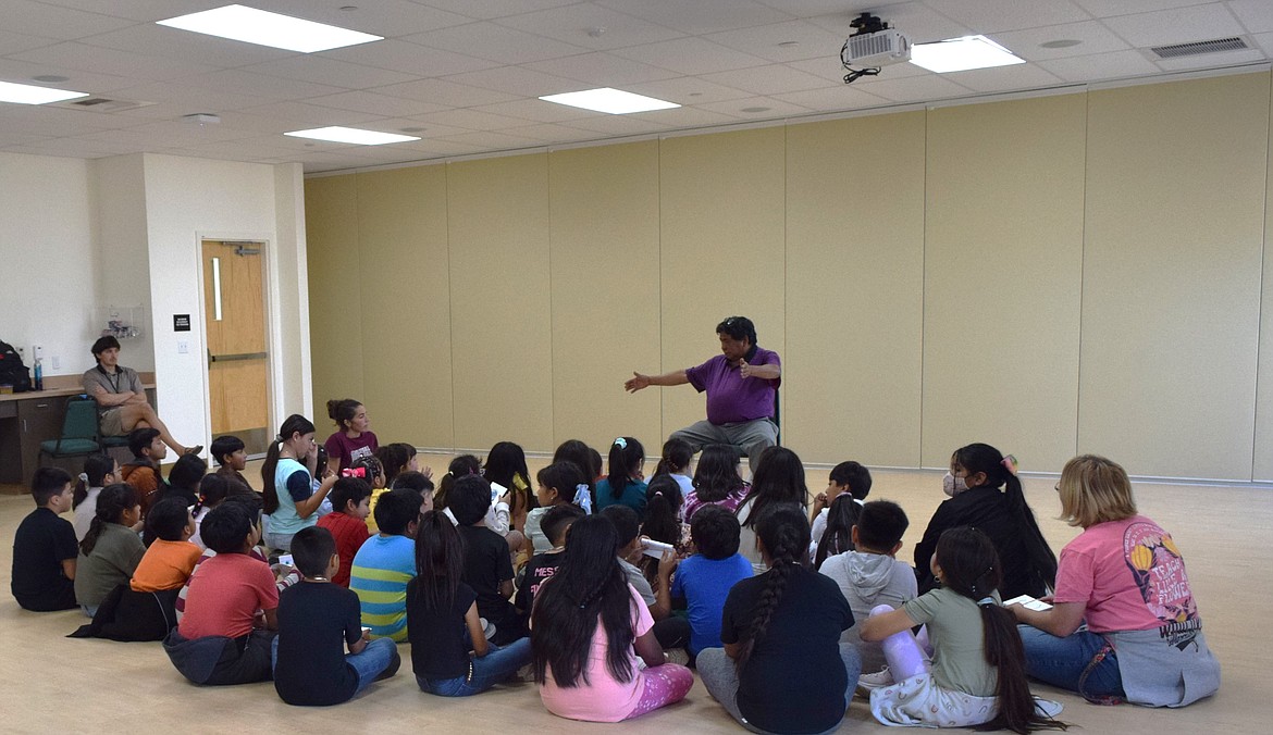 Umatilla Tribe Language Program member Thomas Morning Owl tells the story of the grasshopper and the ant to students at the Wanapum Heritage Center.