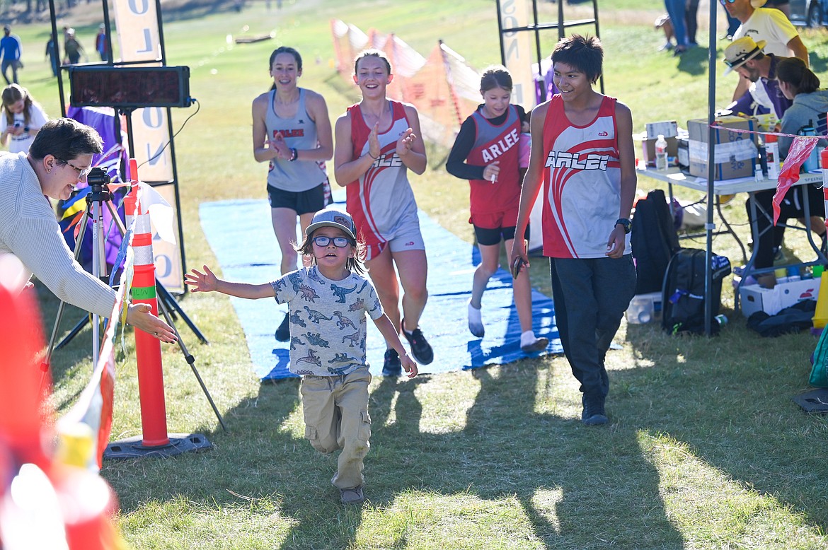 Little runner crosses the finish line during Saturday's Mission Shadow Duels open run at Silver Fox Golf Course in Pablo. (Christa Umphrey photo)