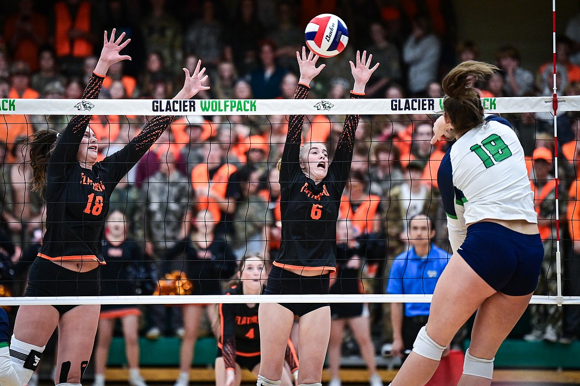 Flathead's Emma Eve (18) and Addison Thornsberry (6) try for a block on Glacier's Allie Krueger (18) at Glacier High School on Tuesday, Oct. 15. (Casey Kreider/Daily Inter Lake)