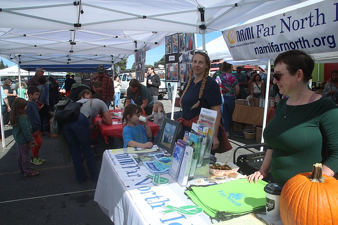 Representatives from NAMI Far North staff a booth at the recent Winter Ridge Neighborhood Food.