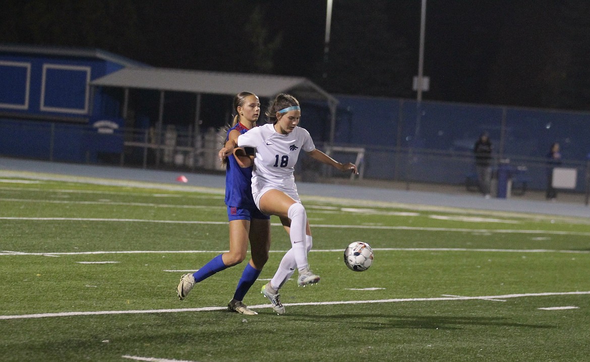 JASON ELLIOTT/Press
Lake City sophomore Riley Brazle attempts to clear the ball from Coeur d'Alene senior Kaylie Smart during the second half of Tuesday's match at Viking Field.