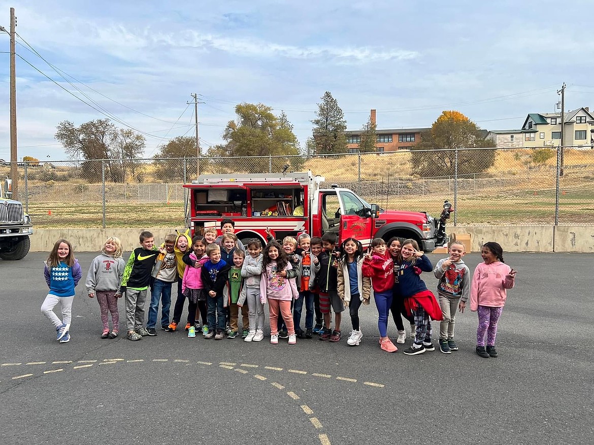 Kindergartners at Lind Elementary School pose for a photo after the Lind Fire Department held an assembly teaching students about fire safety.