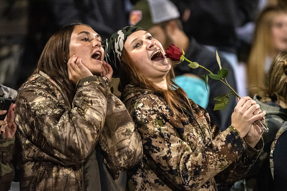 Paeten Gunlock and Piper Lee sing "Sweet Caroline" from the stands at the Homecoming football game Friday, Oct. 12. (Avery Howe/Bigfork Eagle)