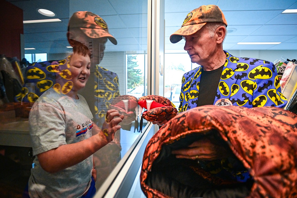 Steve Lerum, right, a manager at Spirit Halloween, takes a snake costume out of the package to play with Jack McIlhargey at Logan Health Children's Spirit of Children event held in coordination with Spirit Halloween on Wednesday, Oct. 16. In the past five years, Spirit of Children has raised $119,403 for Logan Health Children’s. (Casey Kreider/Daily Inter Lake)