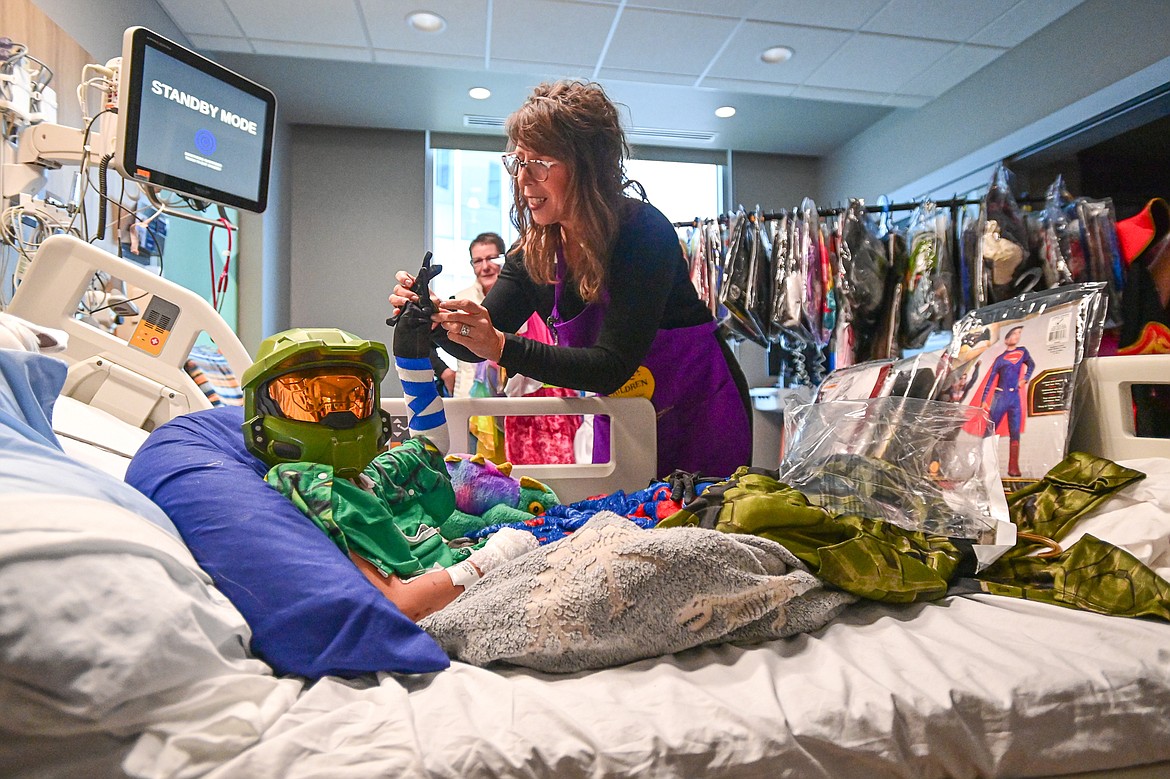 Alex Hanson tries on his Halo costume with the help of Logan Health Children's Child Life Supervisor Amy Rohyans Stewart at the hospital's Spirit of Children event held in coordination with Spirit Halloween on Wednesday, Oct. 16. In the past five years, Spirit of Children has raised $119,403 for Logan Health Children’s. (Casey Kreider/Daily Inter Lake)