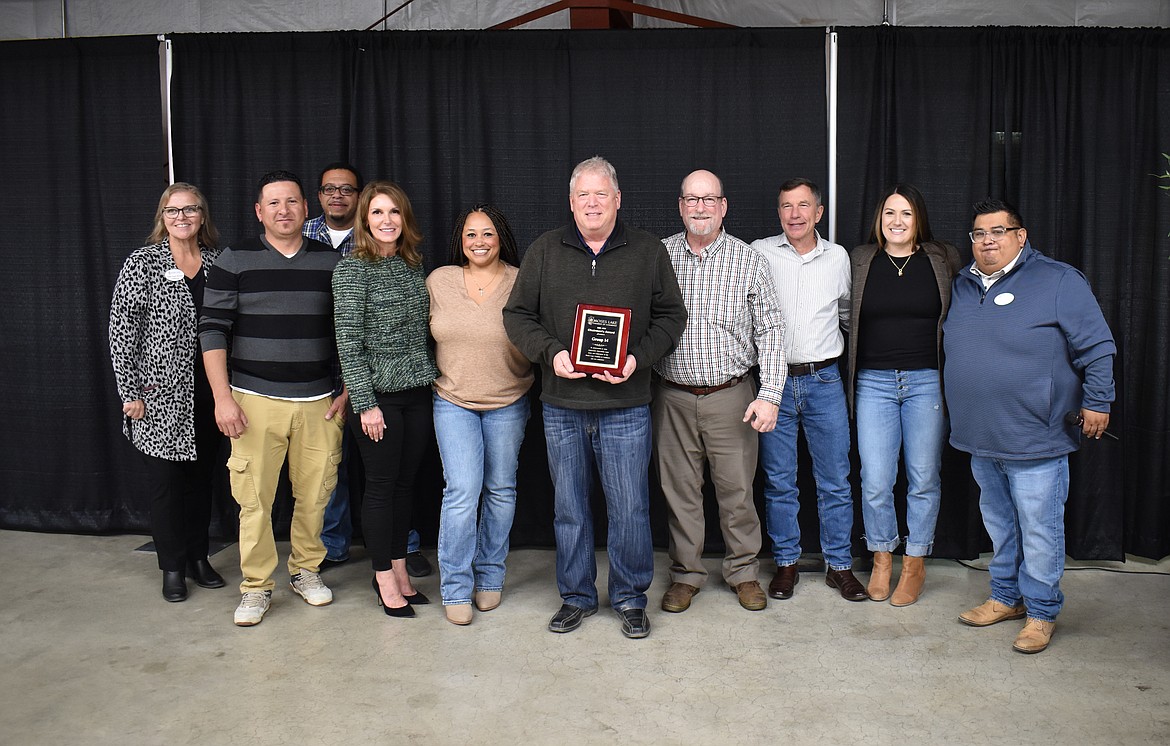 Moses Lake Chamber of Commerce President Debbie Doran-Martinez, far left, and outgoing Board Chair Jason Avila, right, present the Chairman’s Award to (from left) Jose Alejo, Dennis Carheel, Angie Peterson, Yela Bailey, Don Kersey, Eric Robinson, Rick Luebbe and Rachelle Lange of Group14 at the chamber’s annual meeting Tuesday.