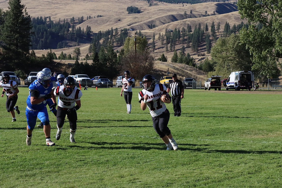 Almira/Coulee-Hartline senior Carter Pitts (11) runs the ball during a Sept. 27 game against Curlew. Pitts leads the Warriors in rushing with 645 yards and three touchdowns.