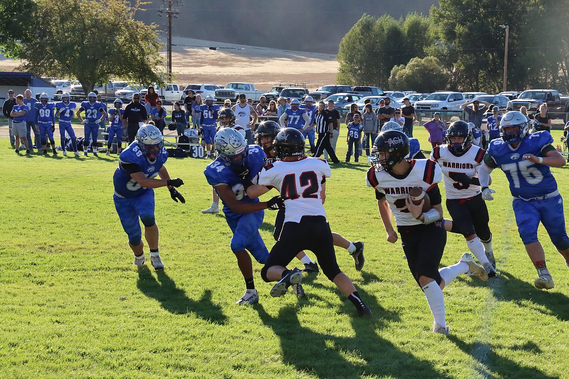 Almira/Coulee-Hartline junior Caden Correia (2) runs around the end during a game against Curlew on Sept. 27. Correia has seen an increase in passing this season, throwing for 585 yards and 11 touchdowns through the first six games of the season.