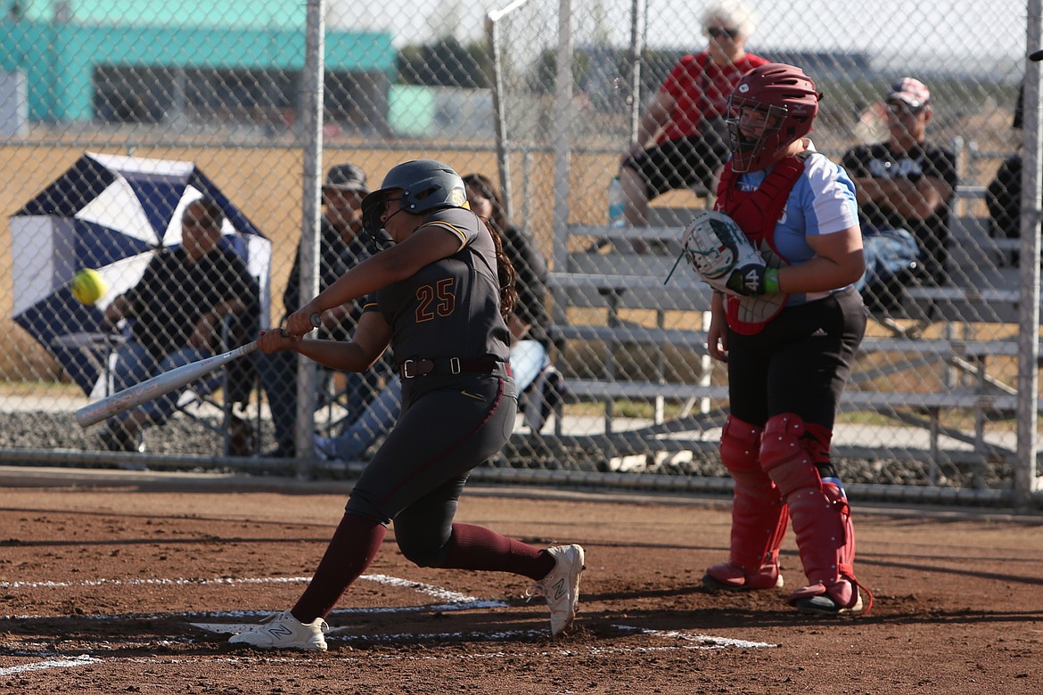 Moses Lake sophomore Amelia Avalos (25) makes contact with a pitch during a game against West Valley (Yakima) on Oct. 8. Avalos hit a three-run home run in the second game of a doubleheader against Eastmont on Thursday.