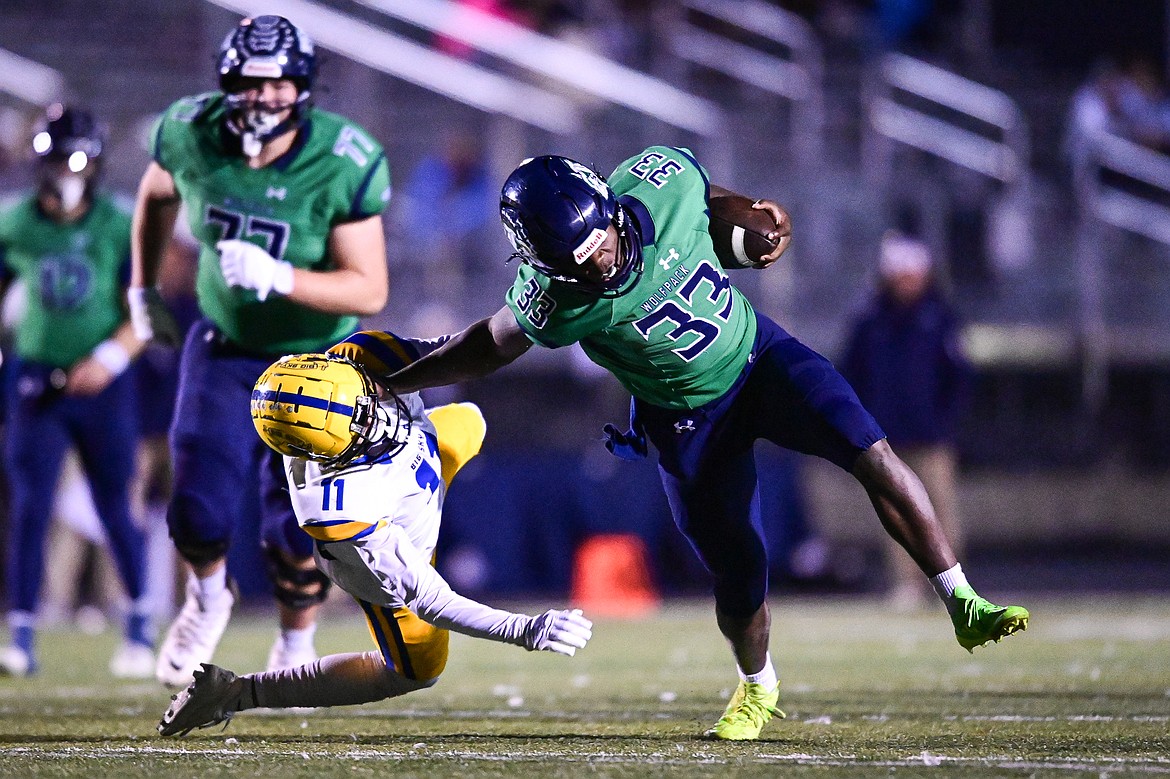 Glacier running back Kobe Dorcheus (33) stiff-arms Missoula Big Sky defender Caleb Hood (11) on a run in the first quarter at Legends Stadium on Thursday, Oct. 17. (Casey Kreider/Daily Inter Lake)