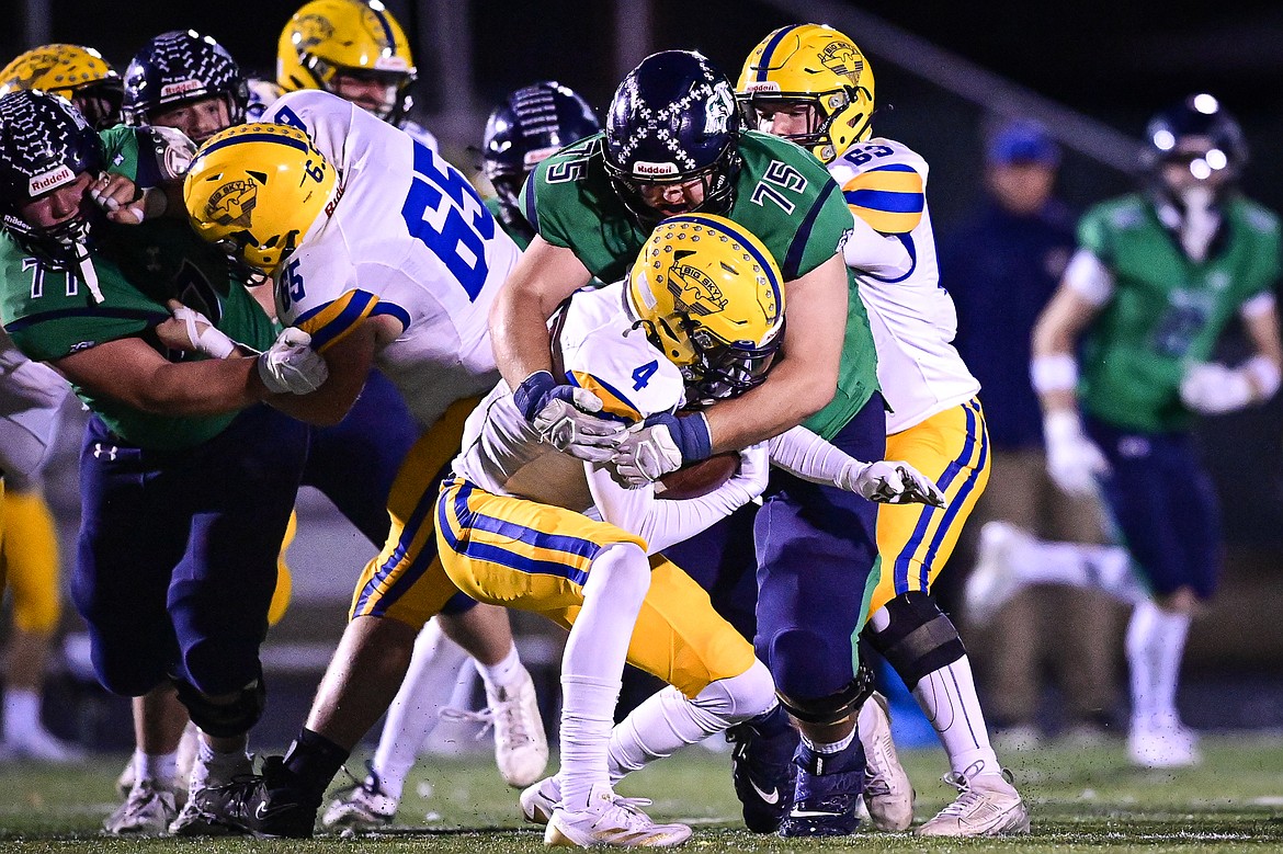 Glacier defensive lineman Ben Winters (75) stops a run by Missoula Big Sky running back Keller Heidrick (4) on third and short in the third quarter at Legends Stadium on Thursday, Oct. 17. (Casey Kreider/Daily Inter Lake)