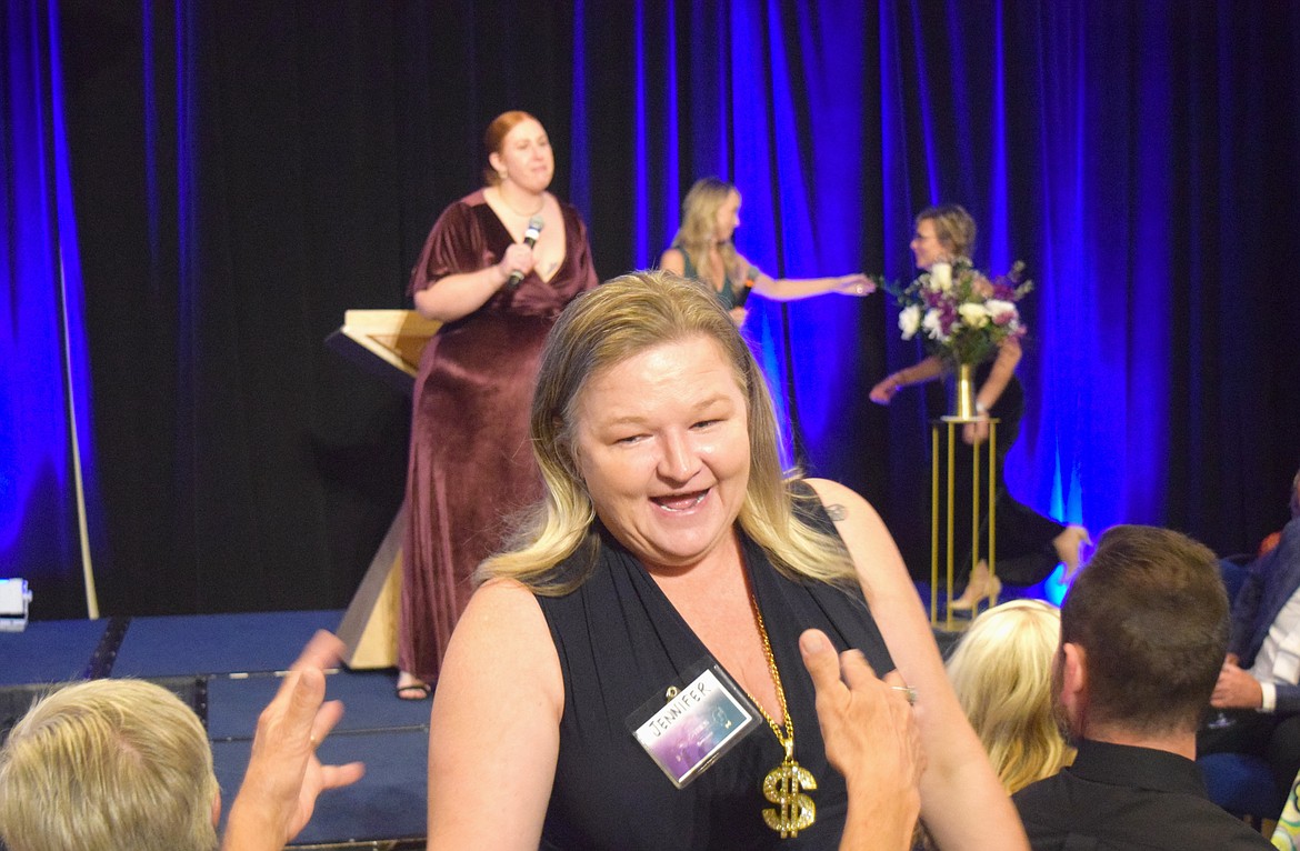 Jennifer Klatt, a volunteer with Safe Passage, celebrates after winning a seven-day trip to the Bahamas through a raffle at Wednesday night's EnVISION gala at The Coeur d'Alene Resort.