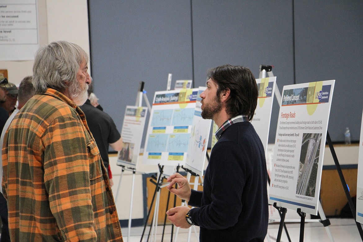 IDT Project Manager Phil Stout, pictured right, speaks with a resident at the Oct. 16 event.