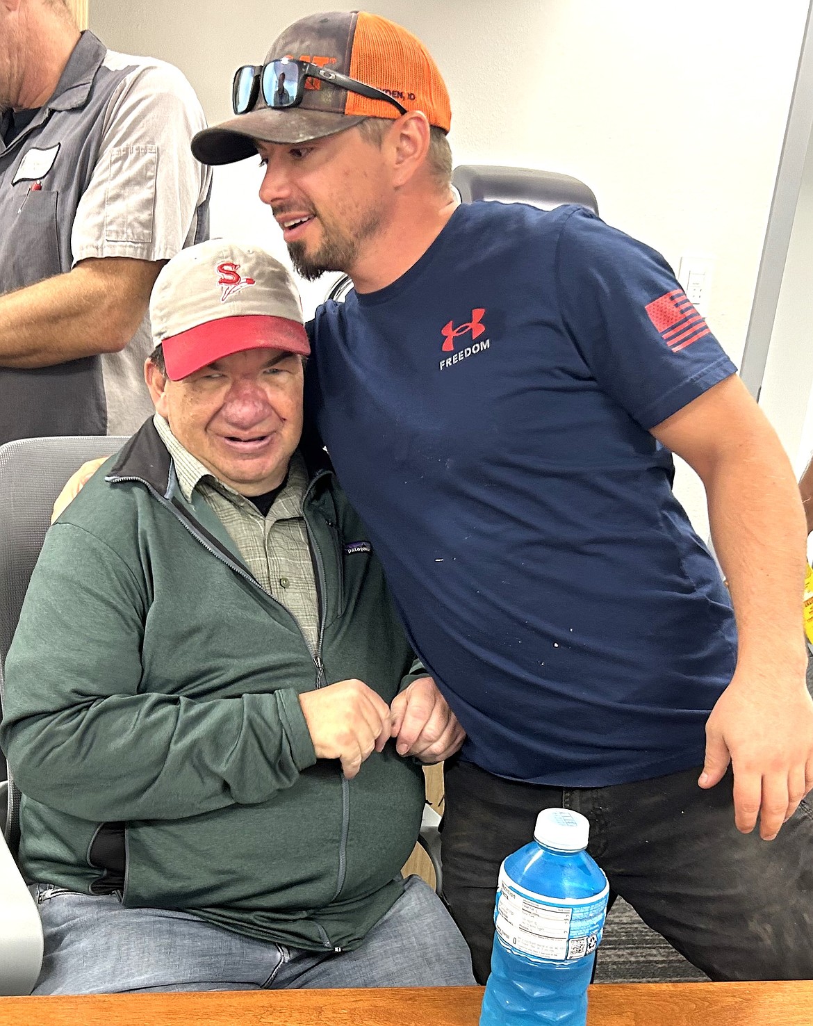 Richard Fortman with the city of Coeur d'Alene gives Jay Leake a hug on a recent visit to the Streets and Engineering Department.