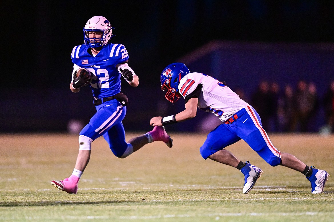 Columbia Falls running back Reggie Sapa (22) looks for running room in the first quarter against Bigfork at Satterthwaite Field on Friday, Oct. 18. (Casey Kreider/Daily Inter Lake)