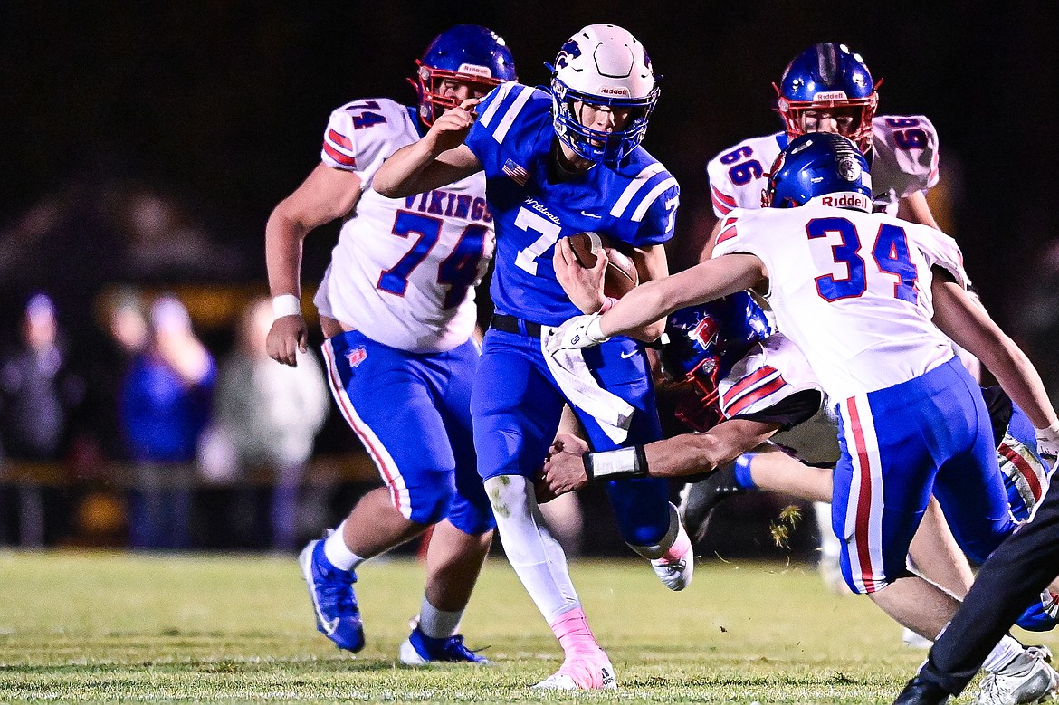 Columbia Falls quarterback Banyan Johnston (7) looks for running room in the first quarter against Bigfork at Satterthwaite Field on Friday, Oct. 18. (Casey Kreider/Daily Inter Lake)