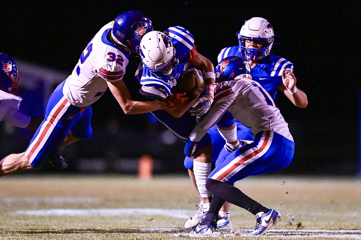 Columbia Falls wide receiver Easton Brooks (10) is tackled by Bigfork defenders Austin (32) and Tamret Savik (11) in the second quarter at Satterthwaite Field on Friday, Oct. 18. (Casey Kreider/Daily Inter Lake)