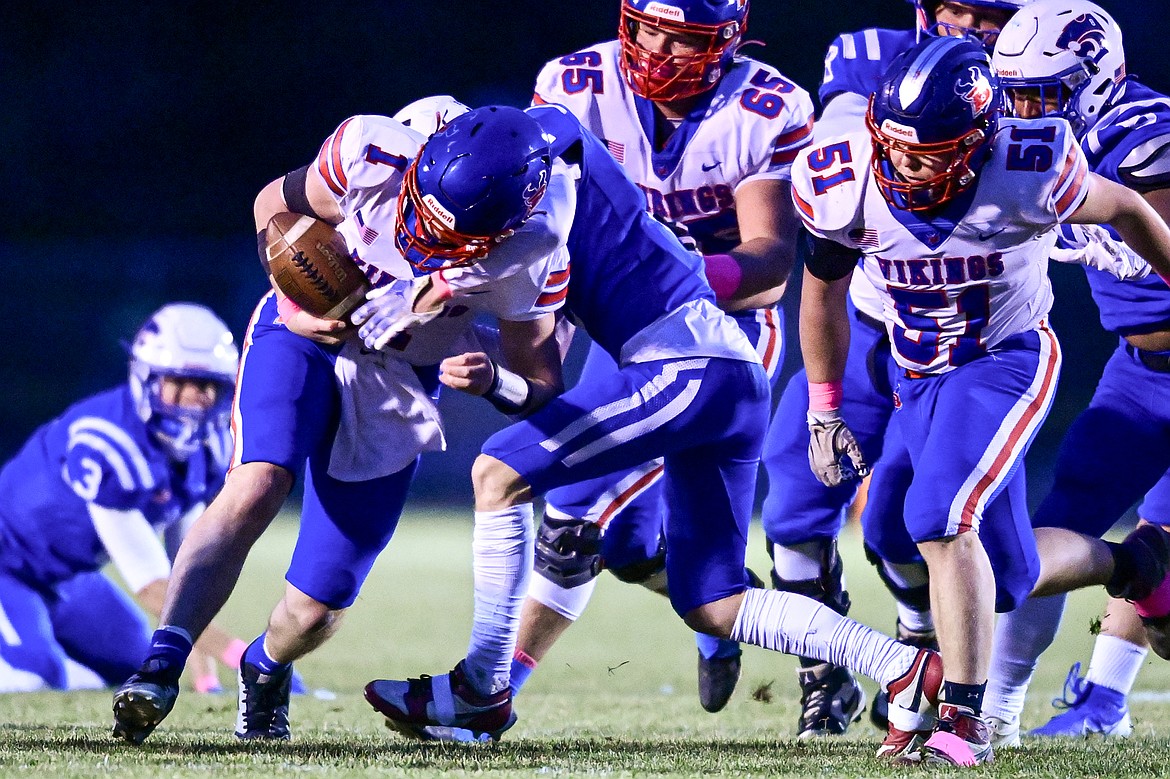 Columbia Falls cornerback Austin Dodson (2) forces a fumble by Bigfork quarterback Cole Schmit (1) on a run in the first quarter at Satterthwaite Field on Friday, Oct. 18. (Casey Kreider/Daily Inter Lake)