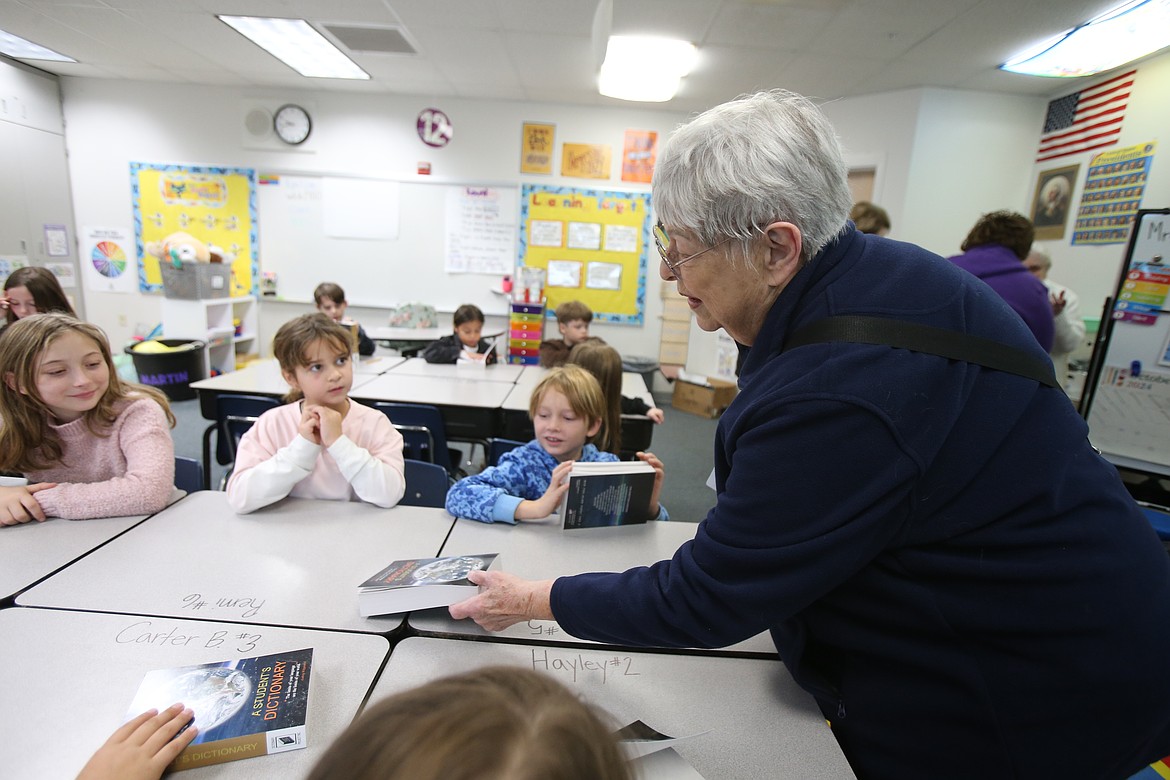 Elks member Janet Grant distributes dictionaries to Skyway Elementary third graders Friday morning.