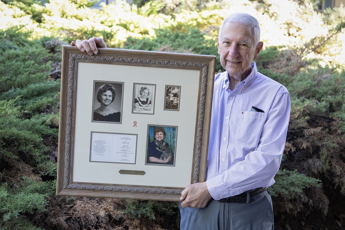 Dr. Jim Bonnet holds a plaque with photos of his sister Carol Ann Bonnet, who died in 2003 after a battle with breast cancer. (photo provided)