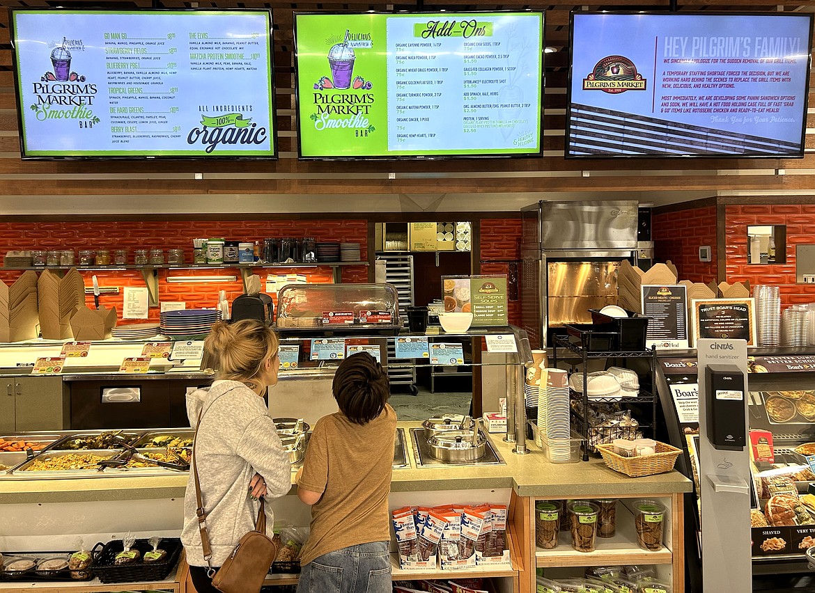 Customers visit the deli area of Pilgram's Market.