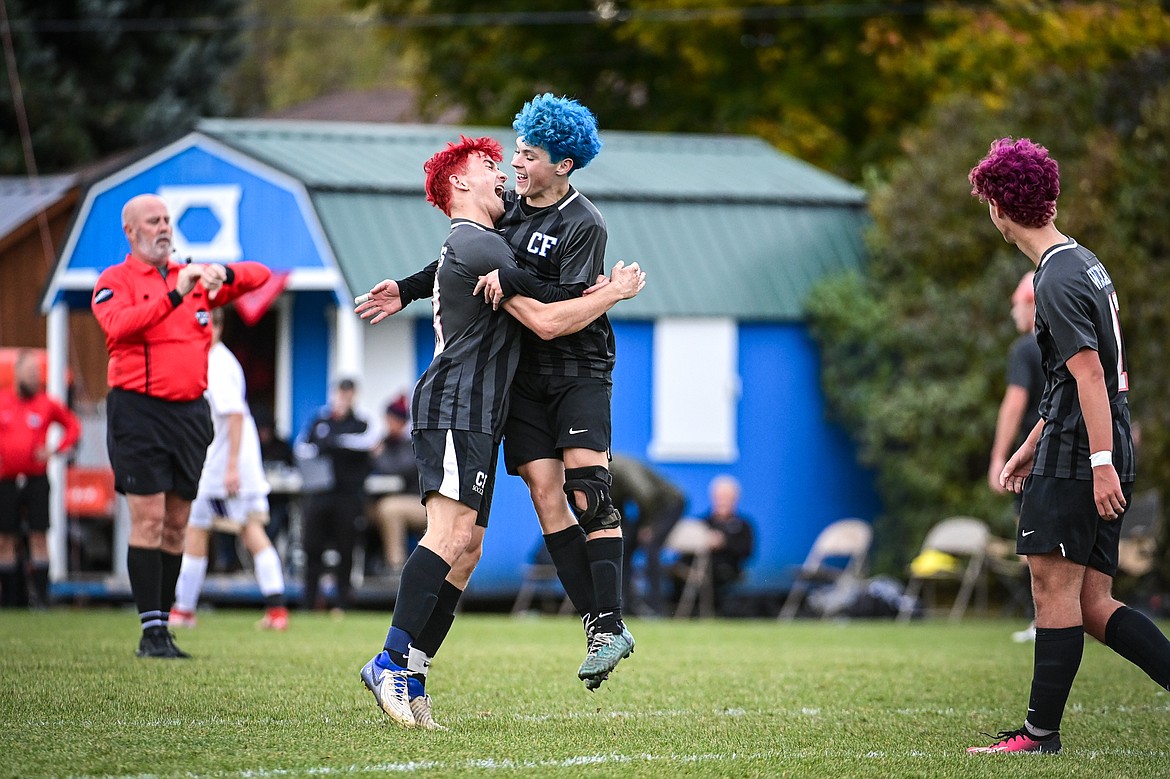 Columbia Falls' Max Everett (13, left) and Isak Soyland (4) celebrate after Everett's goal assisted by Soyland in the second half against Polson during the Class A soccer quarterfinals at Flip Darling Memorial Field on Saturday, Oct. 19. (Casey Kreider/Daily Inter Lake)