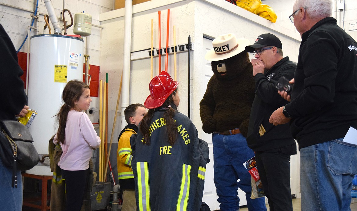 Local kids talk to firefighters and Smokey Bear himself at the Northern Lakes Fire Department open house in Hayden on Saturday.