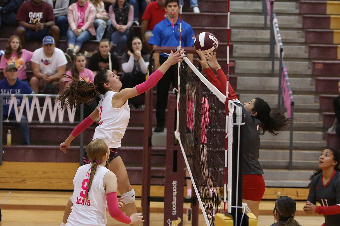 Moses Lake junior Caitlin Decubber tips the ball over the net during a match against Sunnyside on Oct. 10.