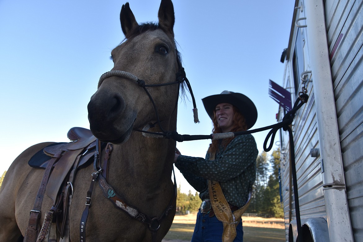 Montana Saddle Clubs Association queen Lilly Erickson saddles up her horse Whiskey in Columbia Falls Oct. 13, 2024. (Hilary Matheson/Daily Inter Lake.)