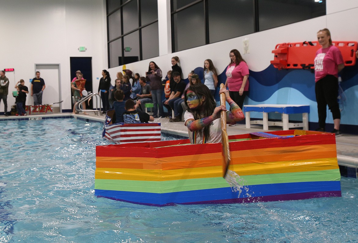 Mackenzie Montague ferociously paddles her "Bad Case of Stripes"-themed boat Monday during Woodland Middle School's cardboard boat races.