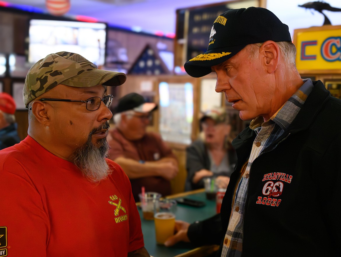 Congressman Ryan Zinke discusses veteran benefits with Army veteran Steve Roque during a campaign stop at the Plains VFW last week. (Tracy Scott/Valley Press)