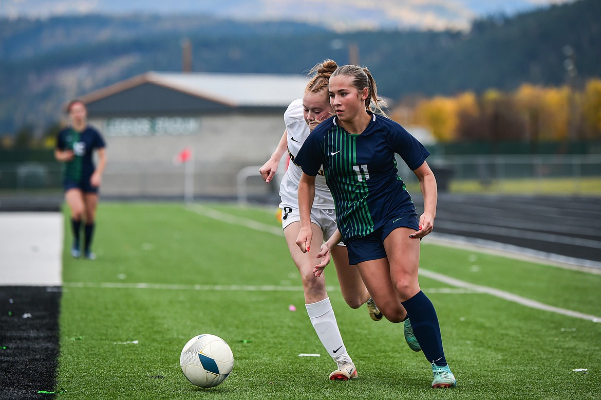 Glacier's Bailee Dahlman (11) moves past a Helena Capital defender in the second half in the first round of the Class AA playoffs at Legends Stadium on Tuesday, Oct. 22. (Casey Kreider/Daily Inter Lake)