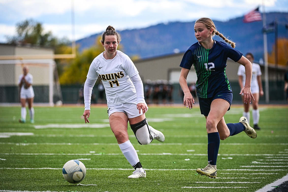 Glacier's Lucy Holloway (12) pushes the ball upfield in the second half against Helena Capital in the first round of the Class AA playoffs at Legends Stadium on Tuesday, Oct. 22. (Casey Kreider/Daily Inter Lake)