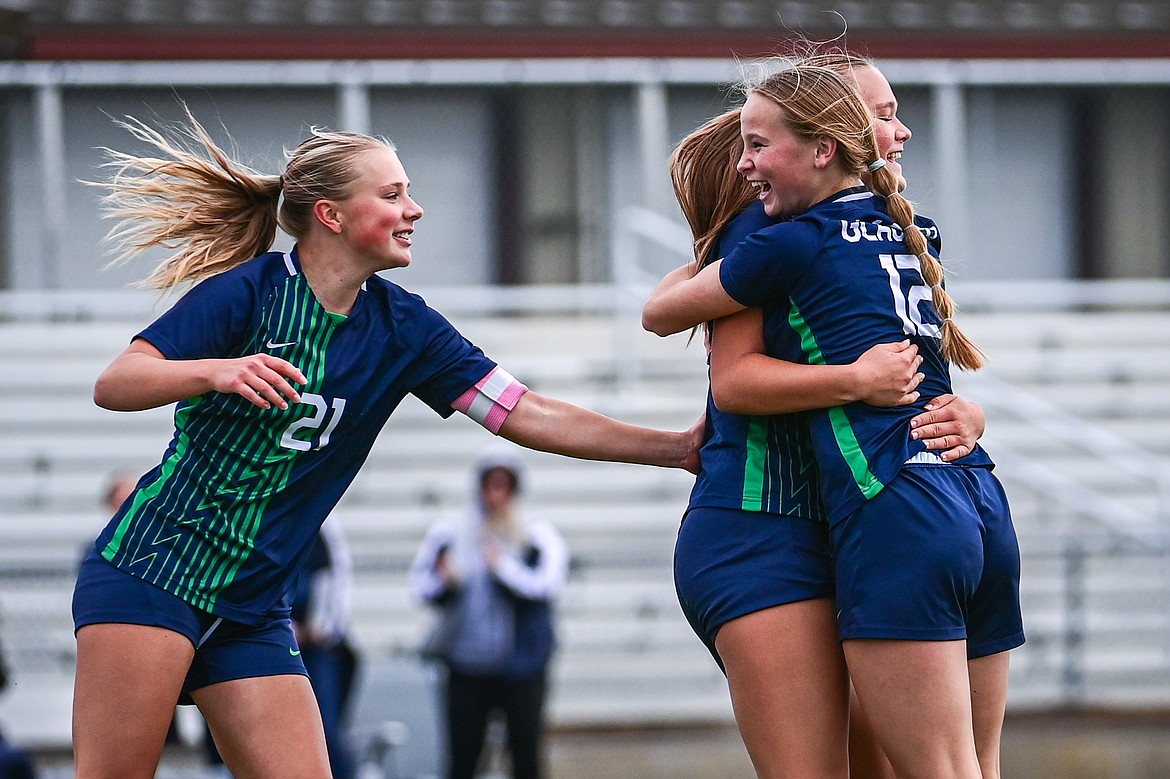 Glacier's Emmery Schmidt (21), Gracie Winkler (10) and Lucy Holloway (12) celebrate after Winkler's goal in the second half against Helena Capital in the first round of the Class AA playoffs at Legends Stadium on Tuesday, Oct. 22. (Casey Kreider/Daily Inter Lake)