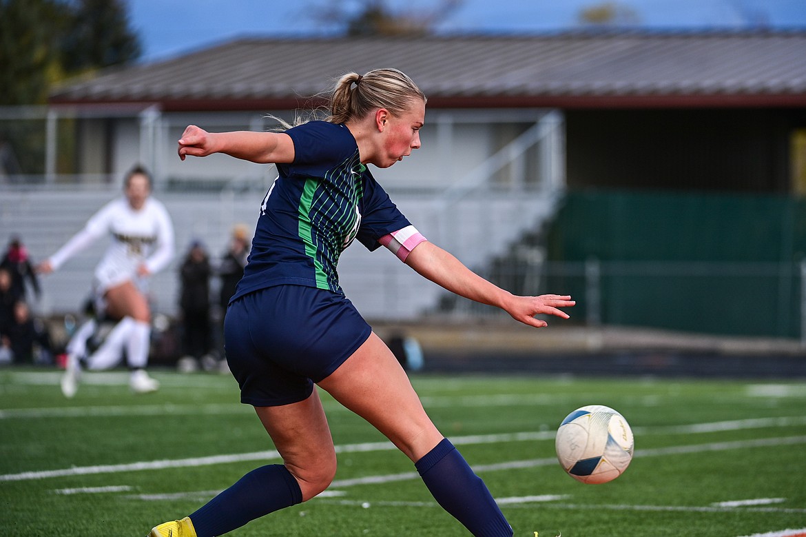 Glacier's Emmery Schmidt (21) lofts a shot on goal which scored when a Capital defender kicked it into her own net trying to clear the ball out of bounds in the first half of the first round of the Class AA playoffs at Legends Stadium on Tuesday, Oct. 22. (Casey Kreider/Daily Inter Lake)