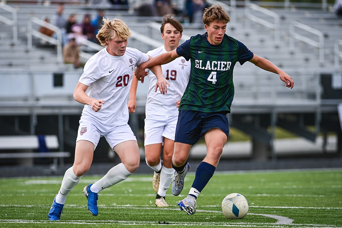 Glacier's Creed Norick (4) pushes the ball upfield in the first half against Helena in the first round of the Class AA playoffs at Legends Stadium on Tuesday, Oct. 22. (Casey Kreider/Daily Inter Lake)