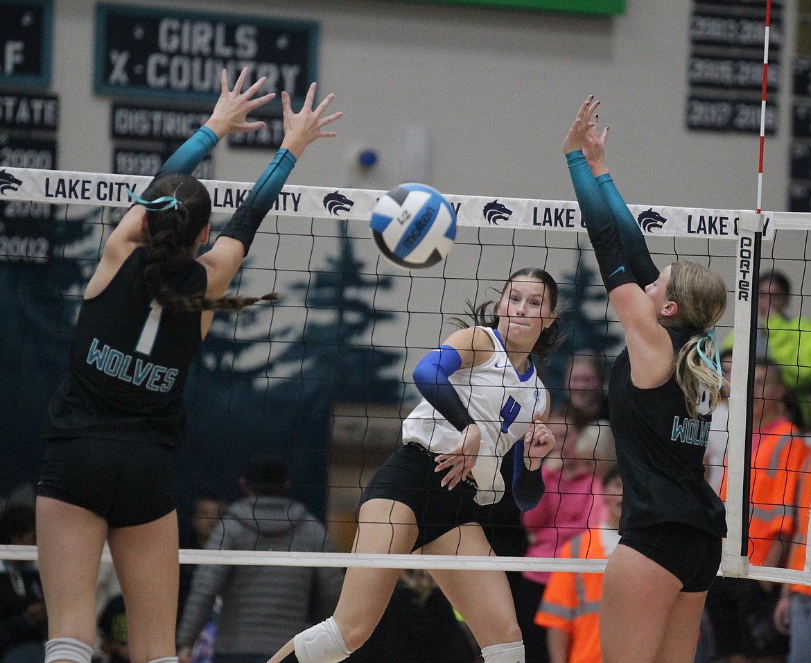 MARK NELKE/Press
Kaylee Paulson (4) of Coeur d'Alene hits between the block of Camryn Woodman (1) and Taylor Winey of Lake City in the second match of a best-of-3 series for the 6A District 1 volleyball championship Tuesday night at Lake City.