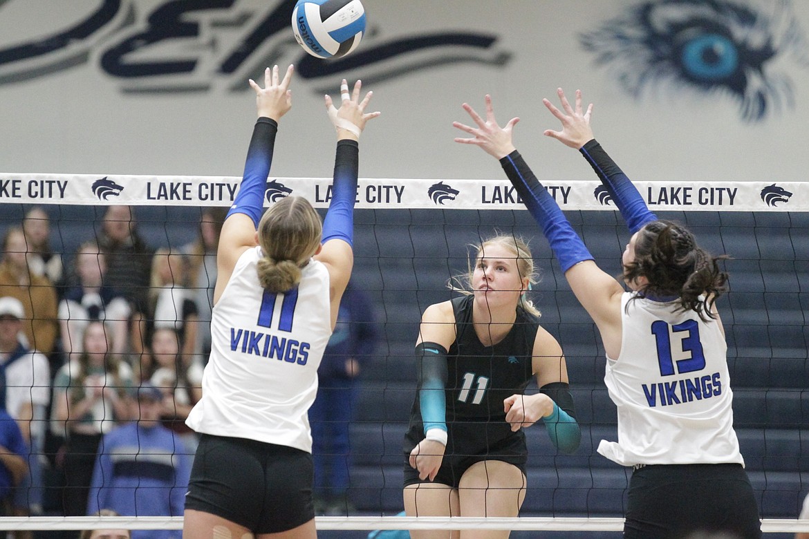 MARK NELKE/Press
Josie Hocking (11) of Lake City hits between the block of Gianna Callari (11) and Hannah Shafer (13) of Coeur d'Alene in the second match of a best-of-3 series for the 6A District 1 volleyball championship Tuesday night at Lake City.