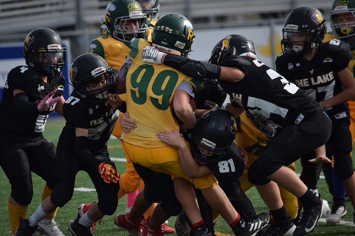 Defenders for the sixth-grade Junior Mavericks go in for a tackle against Richland on Saturday. Richland won the game 19-13.