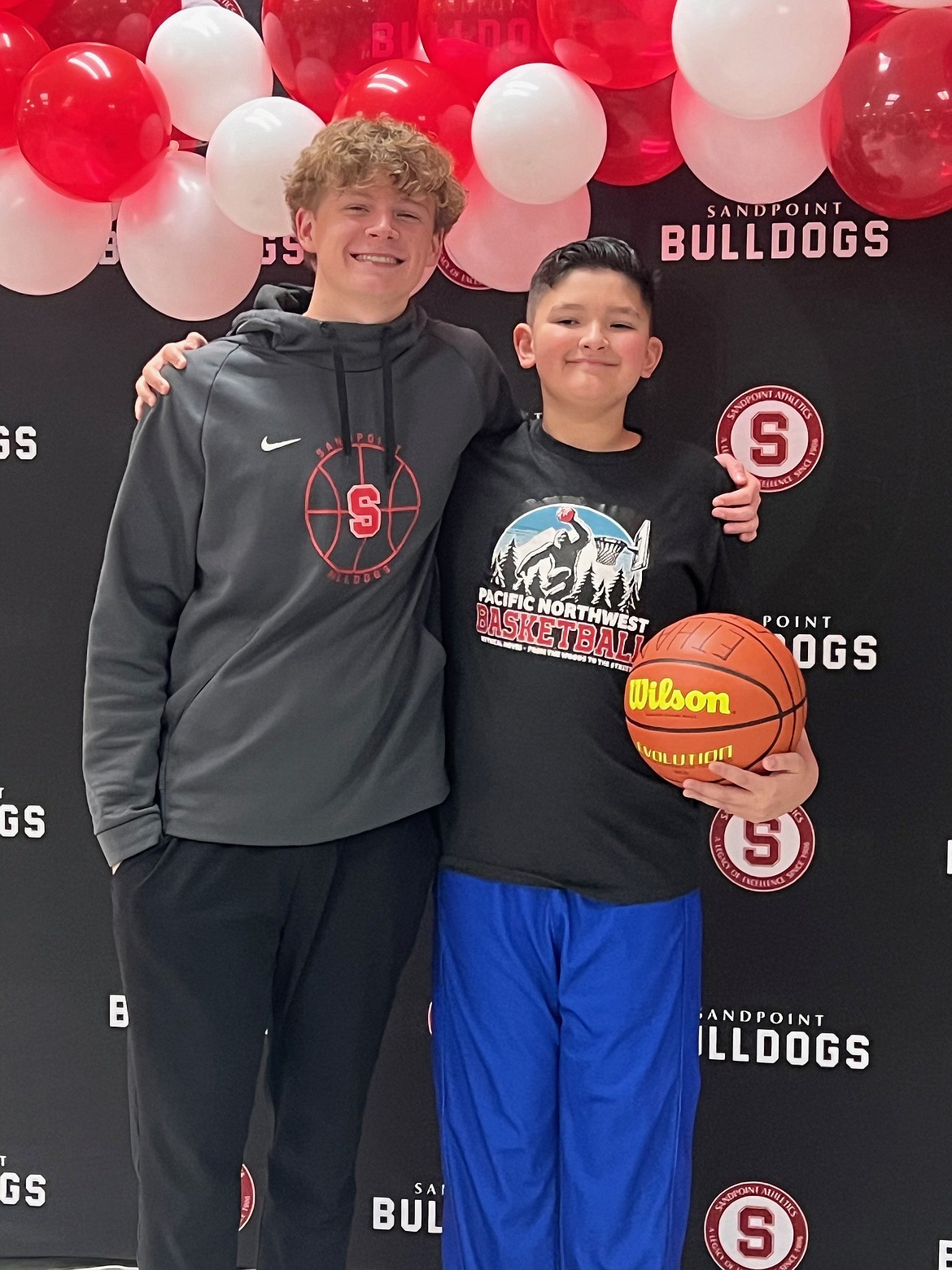 Sandpoint High senior Wil Leisy, a varsity shooting guard for the Bulldogs, is all smiles alongside local AAU player Ethan Garza at the inaugural alumni tournament this past Saturday.