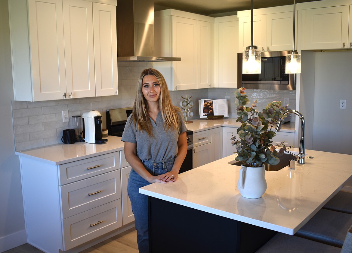 Pro Made Homes Head of Design Rita Maksimchuk stands in the kitchen of the model home at The Refuge at Mae Valley. The model home shows several of the custom options available in the new development.