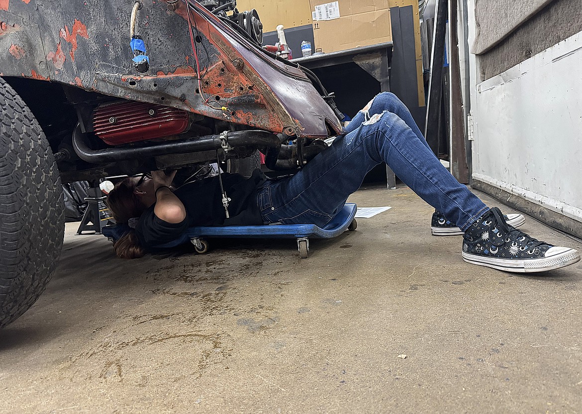 Flathead High School Auto 4 student Lolita Sattler double-checks which bolts and nuts she has to undo to remove the motor of a 1972 Volkswagon Super Beetle she's rebuilding on Wednesday, Oct. 9, 2024. (Hilary Matheson/Daily Inter Lake)