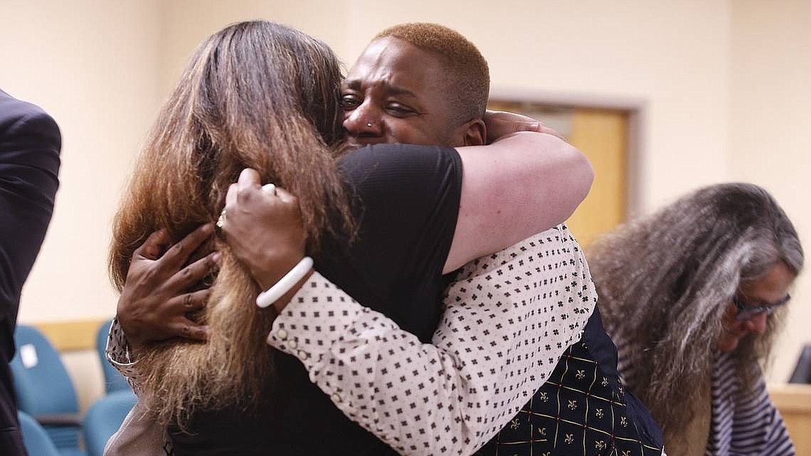 Eric Posey, right, tearfully embraces a supporter after a jury awarded him more than $1.1 million in damages for defamation in May at the Kootenai County District Court in Coeur d’Alene.